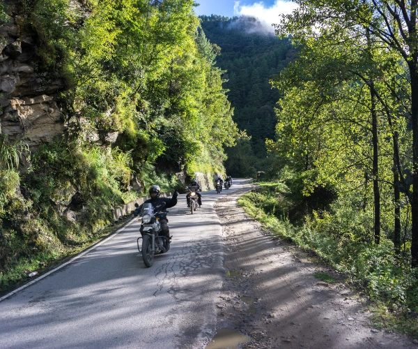 Motorcyclists riding through forest roads in Northeast India