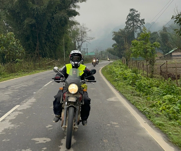 Motorbike tour riding through Northeast India village roads