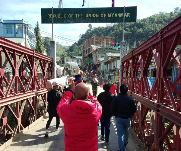 Walking across the Myanmar border on a Mizoram motorcycle tour
