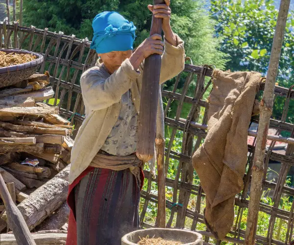Traveller outside a traditional house in Arunachal Pradesh