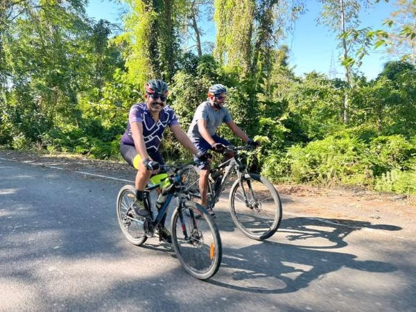 Cyclists riding on a forest road in Arunachal Pradesh