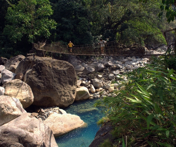 Walking across a suspension bridge on a Meghalaya active family holiday