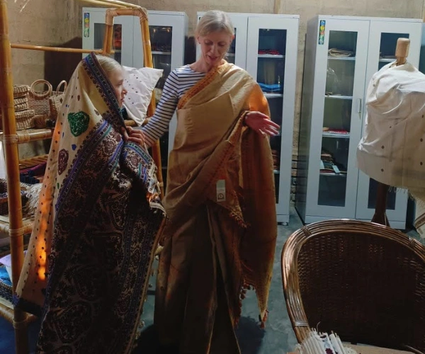 Family trying traditional Assamese textiles