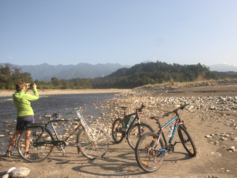 Cyclists beside a rocky riverbed in Arunachal Pradesh