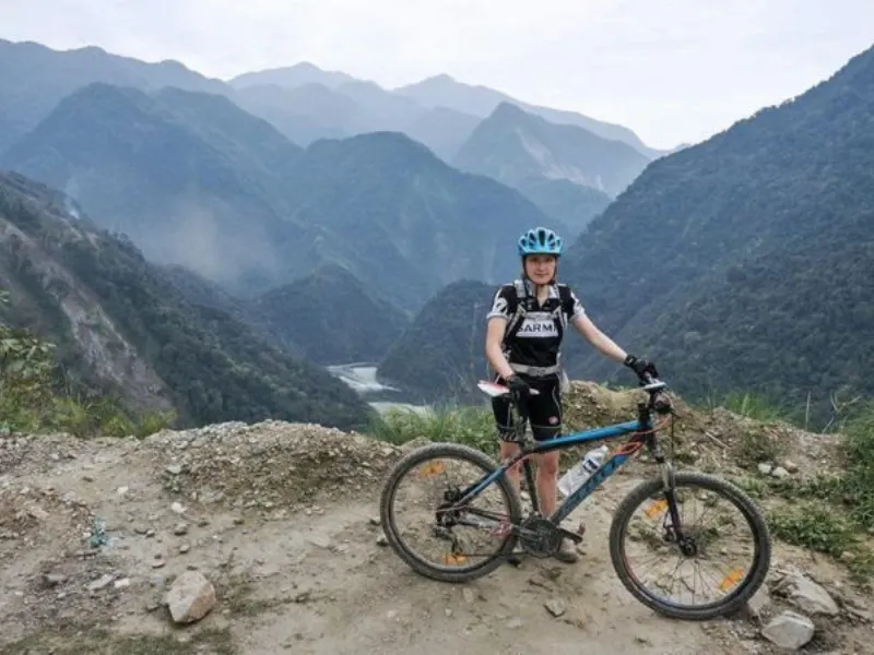 Cyclist above a mountain valley in the Mishmi Hills
