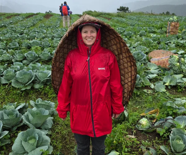 Traveller in rain gear among Meghalaya farms