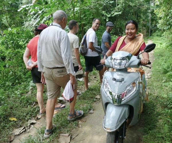 Traveller riding pillion during a village visit