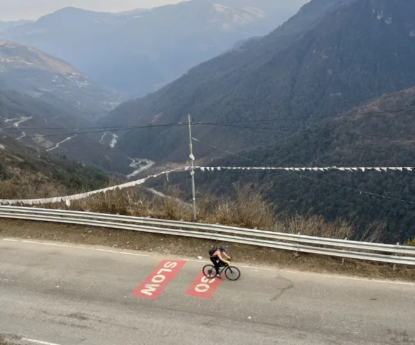 Cyclist descending a high mountain road in Arunachal Pradesh