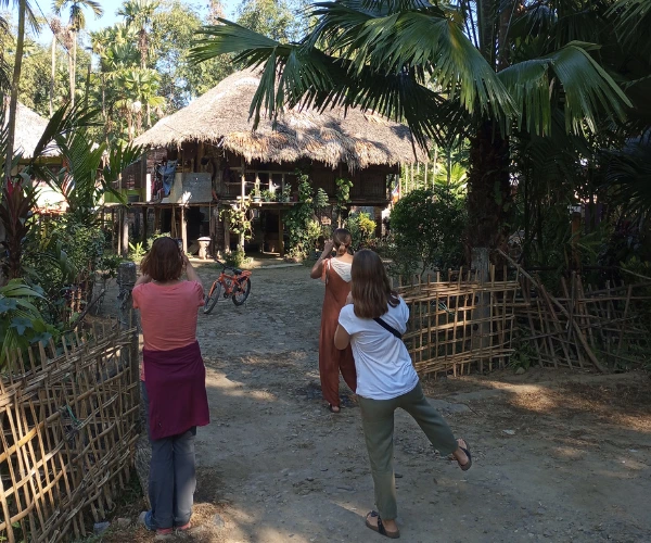 Travellers visiting a traditional house in Northeast India