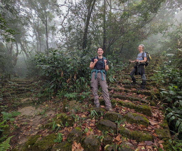 Walkers on a misty forest trail in Meghalaya