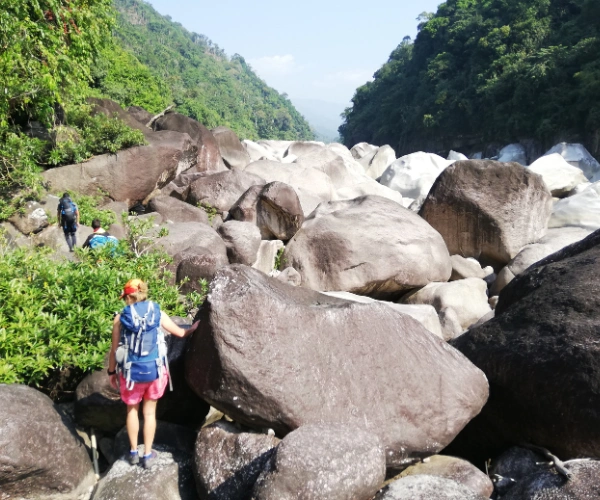 Walkers among giant boulders in Meghalaya