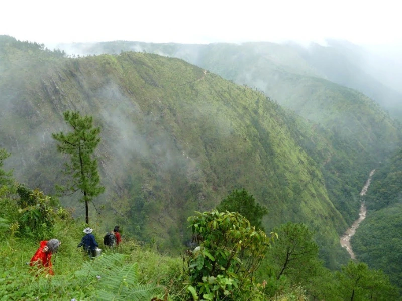 Hikers on a misty ridge trail in Meghalaya