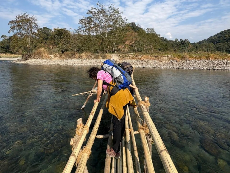Walker crossing a bamboo bridge on an Eastern Arunachal trail