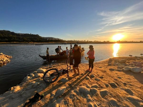Sunset riverbank stop on a cycling holiday in Arunachal Pradesh