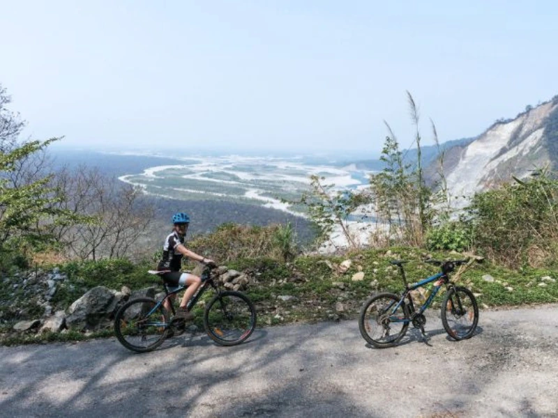Cyclist above a braided river valley in Eastern Arunachal Pradesh