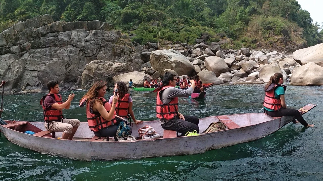 Youth expedition group boating on a river in Meghalaya